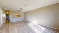 Located at 1846 E Avenue J4 in Lancaster, CA, this single-story, 2-bedroom, 2-bathroom home offers a practical and well-organized layout. Light wood-style flooring runs throughout the entire residence, lending a clean, cohesive look to every room. The open combined living and dining area is bright and airy, featuring a ceiling fan, a textured ceiling, and natural light that pours in through large windows and an exterior door with a view of the surrounding neighborhood. A half-wall pass-through connects the living space to the kitchen, which is laid out in an efficient galley style with white cabinetry, light countertops, a stainless sink, and white appliances including a range. A hallway connects the main living areas to the two bedrooms and two bathrooms. The spacious primary bedroom features a large window that fills the room with natural light. The secondary bedroom includes sliding closet doors and a textured ceiling, consistent with the rest of the home. In total, the home includes four closets, providing ample storage. Both bathrooms are finished with light wood-style flooring, vanities with under-sink storage, and tub/shower combinations. The overall ambiance is bright, neutral, and move-in ready.