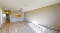 Located at 1846 E Avenue J4 in Lancaster, CA, this single-story, 2-bedroom, 2-bathroom home offers a practical and well-organized layout. Light wood-style flooring runs throughout the entire residence, lending a clean, cohesive look to every room. The open combined living and dining area is bright and airy, featuring a ceiling fan, a textured ceiling, and natural light that pours in through large windows and an exterior door with a view of the surrounding neighborhood. A half-wall pass-through connects the living space to the kitchen, which is laid out in an efficient galley style with white cabinetry, light countertops, a stainless sink, and white appliances including a range. A hallway connects the main living areas to the two bedrooms and two bathrooms. The spacious primary bedroom features a large window that fills the room with natural light. The secondary bedroom includes sliding closet doors and a textured ceiling, consistent with the rest of the home. In total, the home includes four closets, providing ample storage. Both bathrooms are finished with light wood-style flooring, vanities with under-sink storage, and tub/shower combinations. The overall ambiance is bright, neutral, and move-in ready.