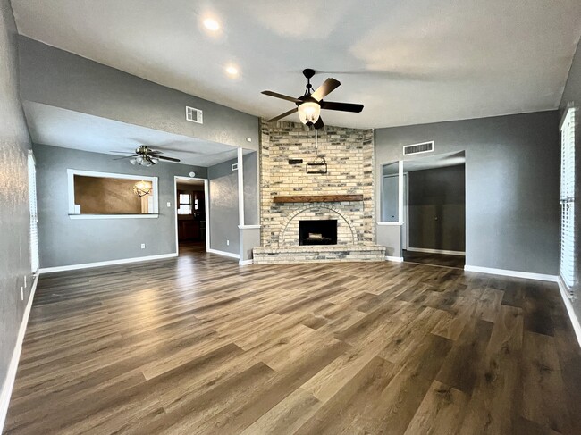 Beautiful fireplace at center of the home - 7450 Emory Oak Ln