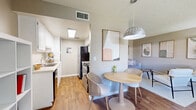 Located at 1201 E Drachman St in Tucson, AZ, this two-bedroom, one-bathroom unit offers a well-organized single-floor layout designed for comfortable everyday living. The living room features neutral-toned walls, plush carpet flooring, and a textured ceiling, creating a relaxed and inviting atmosphere. An adjacent dining area and kitchen provide a practical flow for daily routines, with the kitchen showcasing wood-look flooring, white cabinetry, light stone countertops, and stainless steel appliances. The primary bedroom offers wood-look flooring, a window with vertical blinds for natural light control, and ample space for furnishings. The second bedroom is carpeted and equally well-lit, with a window providing natural light — ideal as a guest room or home office. The bathroom is outfitted with a tub/shower combination, wood-look flooring, and a clean, functional design. A hallway connects the main living areas to the bedrooms and bathroom, while a dedicated closet provides additional storage. Neutral warm-gray walls throughout create a cohesive and calming palette across the entire unit.