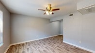 Located at 1912 Green Mountain Dr in Little Rock, AR, this well-designed one-bedroom, one-bathroom unit offers a practical and comfortable single-floor layout. The living room features light-toned wood-look luxury vinyl plank flooring and a ceiling fan with integrated lighting, creating a bright and airy atmosphere. Natural light filters in through a large window, enhancing the open feel of the space. The layout flows seamlessly from the living area into the kitchen, which is outfitted with white cabinetry, granite-look countertops, a stainless steel double sink, and stainless steel appliances including a refrigerator, electric range, and microwave. The bedroom is carpeted for comfort, includes a ceiling fan, a window with blinds for natural light and privacy, and has access to a dedicated closet. The bathroom features a full tub-shower combination with clean white surround panels, complemented by wood-look flooring that ties into the rest of the unit. Neutral gray walls throughout provide a cohesive, modern aesthetic. Ceiling fans in every main room ensure year-round comfort in this thoughtfully laid-out Little Rock residence.