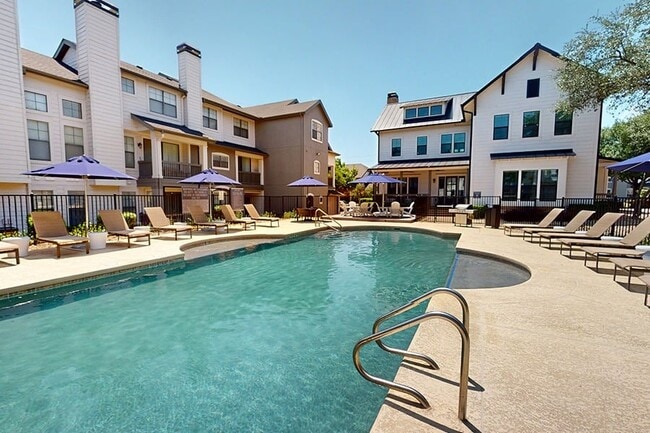 Our resort-style pool includes a sundeck with lounge seating - NoA on McNeil Townhomes + Flats