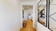 Located at 4980 Red Maple Ln in Wildwood, FL, this single-floor home offers a thoughtfully designed layout with 2 bedrooms, 2 bathrooms, and a cohesive modern aesthetic. Light wood flooring flows throughout, complemented by crisp white walls and recessed lighting that create a clean, airy atmosphere.

The welcoming hallway leads into an open living area featuring large windows that invite natural light. The kitchen is well-appointed with white shaker-style cabinetry, granite countertops, stainless steel appliances — including a French door refrigerator, microwave, and range — and a breakfast bar with seating, ideal for casual dining.

The living room provides a comfortable, open gathering space that connects seamlessly to the kitchen and dining area. The primary bedroom offers a ceiling fan, natural light from a large window, and a well-sized closet, while the second bedroom functions flexibly, with multiple windows and ample natural light. Both bathrooms feature granite countertops and white cabinetry.

A dedicated laundry room includes a full-size washer and dryer with built-in shelving. A closet provides additional organized storage. The home's efficient, single-level floor plan maximizes every square foot, delivering a functional and stylish living environment in the heart of Wildwood.