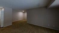 This 710 square foot apartment in Bel Air, Maryland offers a well-designed living space with two bedrooms and one bathroom. The single-floor layout efficiently utilizes every inch of space. The kitchen is a standout feature, boasting white cabinetry, granite countertops, and stainless steel appliances, including a refrigerator and built-in microwave. The living room and bedrooms are carpeted in a warm, neutral tone, while the kitchen and bathroom feature durable wood-look flooring. The primary bedroom, measuring 170 square feet, provides ample space and includes a window for natural light. The bathroom is compact yet functional, with a shower/tub combination and modern fixtures. Throughout the apartment, recessed lighting and a neutral gray color palette create a bright, contemporary ambiance. Storage solutions include closets with wire shelving. The overall design prioritizes functionality and modern aesthetics in this cozy Bel Air residence.