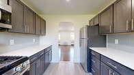 Located at 952 Aurora St, Unit B in Highland Park, NJ, this 3-bedroom, 1-bathroom single-floor unit offers a well-designed layout with a warm, refreshed aesthetic throughout. Rich hardwood floors flow through the open living area, which is bathed in natural light from large windows and accented by recessed lighting overhead. The spacious primary bedroom provides a generous footprint, complemented by two additional bedrooms, each featuring hardwood floors, natural light, and radiator heating. The galley-style kitchen is thoughtfully updated with two-tone dark shaker cabinetry, crisp white countertops, light tile flooring, a subway tile backsplash, and stainless steel appliances, including a full-size refrigerator. A pass-through opening connects the kitchen directly to the living area for ease of flow. The bathroom is a standout feature, finished with floor-to-ceiling marble-look porcelain tile, a soaking tub, chrome fixtures, and a natural light window. A hallway connects the main living spaces efficiently. Clean white walls, classic panel doors, and consistent hardwood flooring tie the entire unit together, creating a cohesive and move-in-ready living environment.