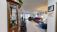 Located at 1555 Homer Rd in Winona, Minnesota, this single-floor, 1-bedroom, 1-bathroom unit offers a functional and comfortable layout. The living room is a standout feature, generously sized with large vertical-blind-covered windows that bring in abundant natural light and provide outdoor views. Soft carpeting and a neutral color palette create a warm, inviting atmosphere throughout.

The galley-style kitchen is efficiently designed with dark wood upper cabinetry lining both walls, white appliances including an electric range and refrigerator, and tile flooring. A dining area adjacent to the kitchen includes a ceiling fan with a light fixture and a window, making it a bright and practical space for meals.

The bedroom offers a comfortable retreat with carpeted flooring, a wide sliding-door closet providing excellent storage, and a window with vertical blinds that allows natural light in. The unit also includes two additional closets, offering plentiful storage throughout.

The bathroom is equipped with a tub-shower combination and includes accessibility-friendly features such as grab bars. A connecting hallway ties the rooms together, completing this compact yet well-organized single-floor layout ideal for comfortable, everyday living in Winona.
