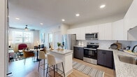 Located in Huntsville, TX, this thoughtfully designed single-floor residence offers 2 bedrooms, 3 bathrooms, and 2 closets within a well-proportioned layout. Light wood-style flooring runs throughout, complementing the clean, contemporary aesthetic of the space.

The kitchen is a standout feature, showcasing two-tone cabinetry with crisp white upper cabinets and dark lower cabinets, granite countertops, a subway tile backsplash, and a full suite of stainless steel appliances. A central island with seating provides an ideal space for casual dining or entertaining.

The living room is bright and welcoming, with natural light streaming through large windows fitted with blinds and sheer curtains. A ceiling fan adds comfort, and the open layout creates a relaxed yet polished atmosphere.

The spacious primary bedroom enjoys natural light from large windows and includes a ceiling fan. The walk-in closet offers generous shelving and hanging space. Three well-appointed bathrooms feature granite-topped dark vanities with matte black fixtures, large mirrors, and marble-style tiled tub and shower surrounds.

The second bedroom is equally comfortable, with natural light and a ceiling fan overhead. Neutral tones and modern finishes are consistent throughout, delivering a cohesive and functional living environment.