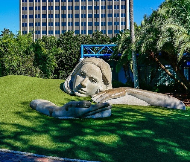 Sit back and relax in the hand of the Muse of Discovery sculpture
