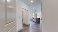 This contemporary 1040 square foot apartment offers a thoughtfully designed living space across a single floor. The open-concept layout seamlessly integrates the kitchen and living room, creating a spacious and inviting atmosphere. The kitchen boasts modern light wood cabinetry, stainless steel appliances, and a stylish backsplash, complemented by granite countertops that extend to a convenient breakfast bar.

Both bedrooms, including the 160 square foot primary bedroom, feature large windows that flood the spaces with natural light, emphasizing the airy feel of the home. The two bathrooms are appointed with granite-topped vanities and ample storage space. One bathroom includes a bathtub, while both offer modern fixtures and finishes.

Throughout the apartment, warm wood-look flooring adds a touch of elegance and continuity. The living areas are graced with multiple windows, providing scenic views and creating a bright, welcoming environment. Ceiling fans in the bedrooms offer additional comfort and air circulation.

Storage is well-considered, with two closets and built-in cabinetry in various rooms. The overall design aesthetic is clean and minimalist, with a neutral color palette that allows for personal customization. This apartment combines functionality with style, offering a perfect balance for modern urban living.