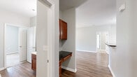 Located at 2500 McArthur Landing Circle in Fayetteville, NC, this well-appointed 2-bedroom, 2-bathroom single-floor home offers a comfortable and functional layout. The open-concept kitchen and living area serves as the heart of the home, featuring warm wood-toned cabinetry, dark granite-style countertops, a breakfast bar peninsula, and black appliances including a refrigerator, range, microwave, and dishwasher. A tiled backsplash and hardwood-style flooring carry throughout the kitchen and living spaces, complemented by a pendant chandelier that adds a touch of elegance to the dining area. The living room extends the open feel with wood-style flooring, neutral gray walls, and ceiling fans for year-round comfort. Both bedrooms are carpeted and bathed in natural light through window blinds with outdoor views of greenery. The primary bedroom offers a generous footprint, while the second bedroom also includes a ceiling fan. Each bathroom is clean and functional — one features a full soaking tub/shower combo, while both include warm wood vanities with ample counter space. A dedicated laundry area houses a full-size washer and dryer with overhead shelving. A separate closet provides additional storage throughout this efficiently designed home.