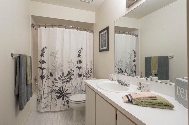 Modern bathroom with vanity mirror at Eastwood Village Apartments in Clinton Township, MI - Eastwood Village Apartments