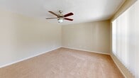 Located at 5122 SE Lisbon Cir in Stuart, FL, this two-story home offers 2 bedrooms and 3 bathrooms across two well-proportioned floors. The main level hosts the kitchen and living room, while the upper floor is dedicated to the bedrooms and additional bathrooms.

The kitchen is a standout feature, showcasing gray shaker-style cabinetry, granite countertops, white tile flooring, and a peninsula that provides extra counter space and casual dining potential. White appliances, including a refrigerator and electric range, complete the functional layout.

The living room is bright and welcoming, with large windows dressed in vertical blinds that frame views of the surrounding greenery, complemented by plush carpeting and a ceiling fan overhead.

Both bedrooms are generously proportioned and carpeted, each featuring ceiling fans for year-round comfort. The spacious primary bedroom offers dual closets with louvered bifold doors. The bathrooms are clean and well-appointed, with one featuring a tiled tub-shower combination and another boasting a wide vanity with granite countertops and gray cabinetry.

A private balcony provides pleasant views of the landscaped grounds, mature palm trees, and the quiet residential surroundings typical of Stuart's warm Florida setting.