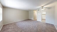 Located at 2050 S Ridgewood Ave in South Daytona, Florida, this one-bedroom, one-bathroom unit offers a practical and comfortable single-floor layout. The open living area features neutral-toned walls, soft wall-to-wall carpeting, and a ceiling fan with a light fixture, creating a relaxed and functional space. The kitchen is efficiently designed with white cabinetry, light countertops, wood-look vinyl flooring, and black appliances including an electric range and full-size refrigerator, along with a double-basin stainless steel sink. The spacious bedroom is carpeted and includes a window that allows natural light to filter in, complemented by a ceiling fan overhead. A standout feature of the bedroom is its generous dual closet storage, with two sets of louvered bi-fold doors providing ample organization space. The bathroom is clean and straightforward, featuring a tub-shower combination with a white surround, a vanity with a light countertop, and wood-look flooring. Throughout the unit, the consistent use of neutral tones and practical finishes creates a cohesive and move-in-ready ambiance well-suited for comfortable everyday living.