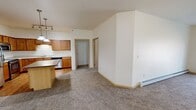 This modern apartment offers 1360 square feet of well-designed living space on a single floor. The layout includes two bedrooms, two full bathrooms, and an open-concept kitchen and living area. The primary bedroom is generously sized at 200 square feet, providing ample space for relaxation.

The kitchen is equipped with stainless steel appliances, wood cabinetry, and a central island, perfect for meal preparation and casual dining. The living area seamlessly connects to the kitchen, creating a spacious feel ideal for entertaining. Large windows throughout the apartment allow for plenty of natural light, while carpeting in the bedrooms and living spaces adds warmth and comfort.

Both bathrooms feature clean, neutral designs with tiled flooring and modern fixtures. The unit includes an in-unit laundry room with a full-size washer and dryer, adding convenience to daily living. Storage is plentiful, with two dedicated closet spaces and additional built-in shelving throughout.

The apartment's neutral color palette and contemporary finishes create a blank canvas for personalization. Located at 4685 49th Ave S #112 in Fargo, ND, this apartment offers a comfortable and functional living space in a convenient location.