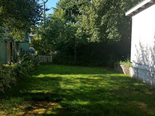 Your backyard with an apple tree that produces tons of apples about this time of the year behind the garage. Lots of gardening space to add to current plants - 1422 N 54TH ST