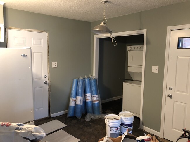 kitchen view to the right and laundry area ready for the new flooring - 208 W Easy St