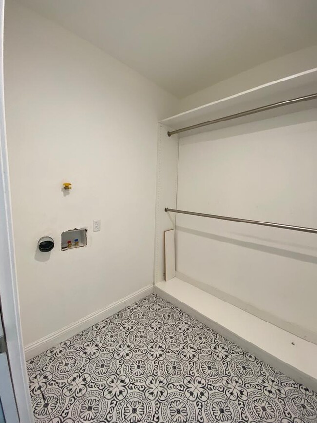 Brand new stackable washer and dryer to be installed in the walk-in closet. - 9345 Woodley Ave