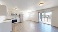 Located at 5102 W State St in Boise, Idaho, this efficiently designed single-floor unit offers a practical and modern layout comprising a living room, kitchen, and bathroom. Light-toned luxury vinyl plank flooring runs throughout the entire space, lending a clean, cohesive aesthetic that enhances the sense of openness.

The open-concept living area flows seamlessly into the kitchen, maximizing the use of the available floor space. The kitchen is outfitted with white cabinetry, a full suite of stainless steel appliances — including a refrigerator, gas range, built-in microwave, and dishwasher — and a single-basin sink. A pendant light fixture adds a subtle decorative touch above the kitchen area.

The living room benefits from a sliding glass door that opens onto a private balcony, inviting natural light into the interior and providing outdoor views. A wall-mounted mini-split HVAC unit ensures efficient climate control year-round. Crisp white walls and textured ceilings contribute to the bright, airy ambiance throughout.

The bathroom features a white vanity with ample counter space, modern hardware, and continued luxury vinyl plank flooring, maintaining the consistent design language found throughout the unit. The overall interior presents a clean, move-in-ready condition with a neutral palette suited to a variety of personal styles.