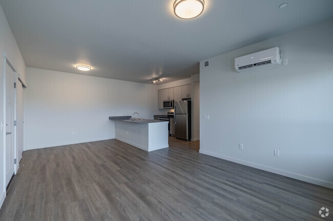 3BR, 2BA - 1,139SF - Living Room and Kitchen - The Goat at Broadmoor