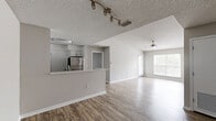 Located in Aventura, Florida, this 3-bedroom, 2-bathroom single-floor residence offers a well-organized layout designed for comfortable everyday living. The open-concept kitchen is a standout feature, showcasing white shaker cabinetry, a decorative hexagonal mosaic tile backsplash, quartz countertops, a peninsula breakfast bar, and a full suite of stainless steel appliances including a refrigerator, electric range, and dishwasher. The kitchen connects seamlessly to the living area, which features wood-look flooring, a ceiling fan with light fixture, and a large window with sliding door access that invites natural light and outdoor views. The bedrooms are finished with wood-look flooring in warm tones and neutral-painted walls. The primary bedroom offers generous proportions with dual bifold closet doors providing ample storage, while a separate walk-in closet with wire shelving adds further utility. An additional bedroom features a bright window overlooking greenery. Both bathrooms are appointed with white subway-tiled tub-shower combinations, stone-top vanities with white cabinetry, and framed mirrors. Textured ceilings and clean white baseboards are consistent throughout, contributing to the home's fresh, cohesive aesthetic.