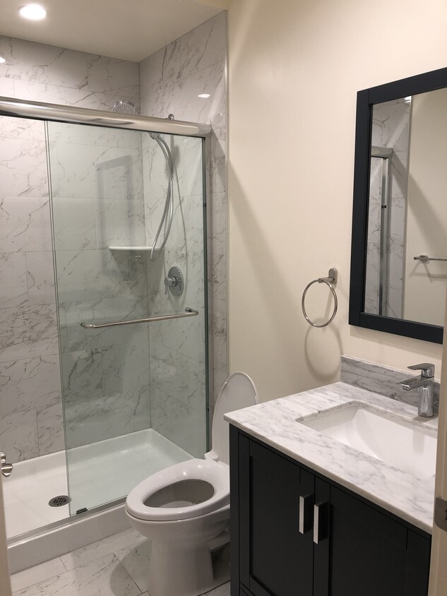 Shared bathroom with marble countertop. - 1375 Plymouth Ave