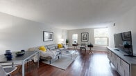 Located at 856 N Clark Street in Chicago's dynamic River North neighborhood, this single-floor unit offers a well-organized layout connecting several distinct living spaces through a central hallway. Rich hardwood flooring flows throughout the main living areas, adding warmth and continuity to the overall design.

The spacious living area is a standout feature, benefiting from multiple windows that draw in generous natural light and offer views of the surrounding greenery. The open arrangement comfortably accommodates both a seating area and a workspace, making it versatile for everyday living. Neutral gray walls and a textured ceiling complement the warm tones of the hardwood floors throughout.

The kitchen is efficiently laid out, featuring warm oak cabinetry, granite countertops, and a full suite of appliances including an electric range. Ample counter space and storage make this a practical cooking area.

The bedroom is carpeted for comfort and includes a closet with open shelving. A window allows natural light into the room, maintaining the bright and airy atmosphere found throughout the unit. The bathroom is clean and functional, featuring a wood-toned vanity, a large mirror with overhead lighting, and tile flooring.

The unit's location on N Clark Street places it within easy reach of Chicago's dining, shopping, and transit options.