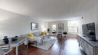 Located at 856 N Clark Street in Chicago's dynamic River North neighborhood, this single-floor unit offers a well-organized layout connecting several distinct living spaces through a central hallway. Rich hardwood flooring flows throughout the main living areas, adding warmth and continuity to the overall design.

The spacious living area is a standout feature, benefiting from multiple windows that draw in generous natural light and offer views of the surrounding greenery. The open arrangement comfortably accommodates both a seating area and a workspace, making it versatile for everyday living. Neutral gray walls and a textured ceiling complement the warm tones of the hardwood floors throughout.

The kitchen is efficiently laid out, featuring warm oak cabinetry, granite countertops, and a full suite of appliances including an electric range. Ample counter space and storage make this a practical cooking area.

The bedroom is carpeted for comfort and includes a closet with open shelving. A window allows natural light into the room, maintaining the bright and airy atmosphere found throughout the unit. The bathroom is clean and functional, featuring a wood-toned vanity, a large mirror with overhead lighting, and tile flooring.

The unit's location on N Clark Street places it within easy reach of Chicago's dining, shopping, and transit options.