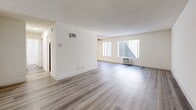 This 630 square foot apartment in Los Angeles offers a thoughtfully designed living space that maximizes functionality. The single-floor layout comprises one bedroom, one bathroom, and an open-concept kitchen and living area. The primary bedroom, measuring 170 square feet, provides ample space for comfort.

The interior showcases a modern aesthetic with a neutral color palette. Bright white walls and ceilings create a sense of openness, while durable wood-look flooring in a light gray tone unifies the space and adds warmth. The kitchen features crisp white cabinetry, stainless steel appliances, and a practical layout that optimizes the compact area.

Large windows in the living area and bedroom allow natural light to flood the space, enhancing the airy ambiance. The bathroom is equipped with essential fixtures, including a bathtub-shower combination, and continues the clean, modern design theme.

Climate control is provided by a wall-mounted air conditioning unit, ensuring comfort year-round. The apartment's efficient design incorporates built-in storage solutions, such as mirrored closet doors in the bedroom, to maximize space utilization.

This apartment offers a blend of style and practicality, ideal for those seeking a contemporary urban living experience in a prime Los Angeles location.