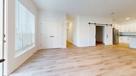 This expansive 7,880 square foot single-floor unit in Hartland, Wisconsin, offers a blend of space and modern amenities. The property boasts six bedrooms, including a remarkably large primary bedroom of 3,490 square feet, providing ample space for rest and relaxation. Two well-appointed bathrooms serve the unit, ensuring convenience for residents and guests alike.

The heart of the home is a contemporary kitchen, featuring sleek white cabinetry, stainless steel appliances, and a spacious island with a granite countertop. Pendant lighting adds a touch of elegance to the culinary space. The open-concept design seamlessly connects the kitchen to the living areas, ideal for entertaining and daily living.

Throughout the unit, light-toned hardwood flooring creates a warm and inviting atmosphere, complemented by crisp white walls that enhance the sense of spaciousness. Large windows in various rooms allow natural light to flood the interior, while offering views of the surrounding area.

The bathrooms are designed with functionality and style in mind, featuring modern fixtures, granite countertops, and a combination of tub and shower options. Additional amenities include a balcony for outdoor enjoyment and multiple entrance points for easy access.

Storage is abundant, with two dedicated closet spaces and built-in wire shelving systems. The unit's three separate entrances provide flexibility and potential for various living arrangements. Located in Building SF1, this Floor Plan F2 unit offers a unique living experience, combining spaciousness with modern design in a prime Hartland location.