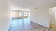 Located at 1194 Casa Brazilia Dr in Saint Louis, MO, this two-story residence offers 2 bedrooms and 2 bathrooms across two floors. The main level comprises the larger portion of the home and houses the open-concept kitchen and living room. The kitchen is appointed with rich dark wood cabinetry, granite-style countertops, a peninsula with bar seating, recessed lighting, and tile flooring. It flows seamlessly into the living room, which features light wood-style laminate flooring, a ceiling fan, and a wide bank of windows that invite abundant natural light and views of the surrounding neighborhood. A sliding glass door provides access to an outdoor balcony area. A hallway and bathroom are also located on the main level, with the bathroom featuring a lighted vanity mirror, white sink, and clean neutral finishes. The upper floor contains both bedrooms, a second bathroom, a closet, and a hallway. The spacious primary bedroom includes a ceiling fan and window with outdoor views. The second bedroom similarly features light wood flooring, a ceiling fan, and multiple windows offering views of the exterior surroundings. Throughout, the home maintains a bright, neutral palette with clean white walls and consistent light flooring, creating a cohesive and airy ambiance.