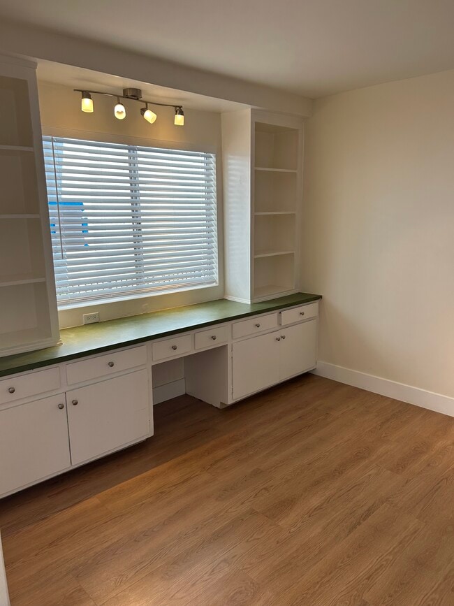 Den with large window and built in cabinets. - 1137 12th St
