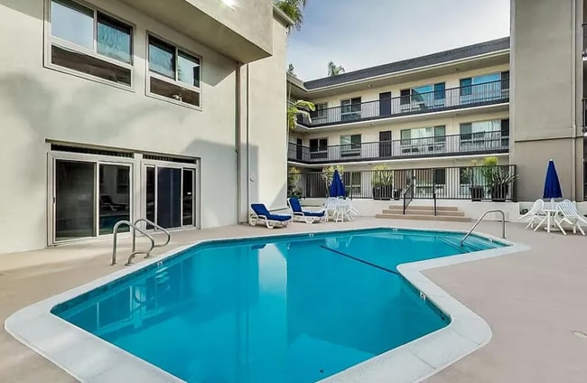 Pool view from the pool deck. Rec room is on the left side. - 6001 Canterbury Dr