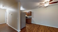 Located at 651 Schiller St in Sun Prairie, Wisconsin, this single-floor unit offers a thoughtfully laid-out living space with a cohesive design throughout. Rich hardwood-style flooring flows through the main living areas, complemented by neutral wall tones that create a warm and inviting atmosphere. The open living area is spacious and well-lit, featuring ceiling fans that add both function and comfort.

The kitchen is a standout feature, offering an abundance of warm-toned wood cabinetry, dark granite-style countertops, and stainless steel appliances including a full-size refrigerator and range. The galley-style layout provides ample counter and storage space, making it highly functional for everyday use.

The bedrooms are carpeted for comfort and receive natural light through sliding windows that frame views of surrounding greenery. Each room also includes baseboard heating. A generously sized walk-in closet with dual shelving and hanging rods provides excellent storage capacity.

The bathroom is finished with matching wood cabinetry, a wide vanity with a light-toned countertop, a large mirror with overhead lighting, and hardwood-style flooring that continues the consistent design language of the unit. The entry area includes two separate doors and additional ceiling fan lighting, rounding out this well-appointed single-level home.