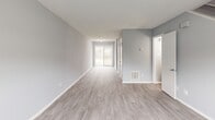 Located at 3716 Groometown Rd in Greensboro, NC, this two-story home offers a well-organized layout spread evenly across both floors. The main level features a living room with light luxury vinyl plank flooring and large sliding glass doors that invite natural light, flowing into a dedicated dining area. The kitchen is efficiently designed with white cabinetry, light countertops, a black electric range, and a window overlooking the exterior. Upstairs, three carpeted bedrooms provide comfortable retreats, each finished in soft gray tones with textured ceilings and natural light from windows with blinds. The primary bedroom includes its own closet, while additional bedrooms also feature generous closet space — with six closets total throughout the home. Two full bathrooms serve the residence; one includes a tub/shower combo, wood-look vinyl flooring, a single vanity, and clean white fixtures. A hallway connects the upper-level rooms, and two staircases provide convenient circulation between floors. Throughout the home, a consistent neutral gray palette, white trim, and durable flooring choices create a clean, move-in-ready aesthetic suited for comfortable everyday living.