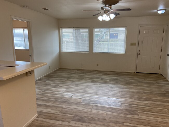 Open Living Area with large windows and ceiling fan - tile not as pictured - 12811 Broughton Way