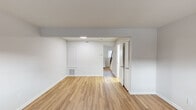 Located at 74 Denise Dr in Burlington, NC, this two-floor home offers a clean, functional layout with thoughtful updates throughout. The main level welcomes you through a paneled front door into a bright, open living area featuring warm hardwood-style flooring and neutral gray-toned walls that create a fresh, move-in-ready atmosphere. Natural light filters in through front-facing windows, enhancing the airy feel of the space.

The kitchen is well-appointed with white cabinetry, granite-look countertops, a stainless steel electric range with a range hood, a sink, and a convenient in-unit washer and dryer tucked along the back wall. A secondary door from the kitchen provides additional exterior access. The main level bathroom includes a full tub-shower combo with white tile surround and subway tile accents, paired with a toilet and clean finishes throughout.

The lower level features additional open living space with light wood-style flooring, recessed lighting, and a compact utility sink — ideal for a flex room or secondary living area. Upstairs, the carpeted bedrooms offer a quiet retreat, with windows providing natural light and views of the surrounding neighborhood. The home's straightforward design and updated finishes make it a practical and comfortable residence in Burlington.