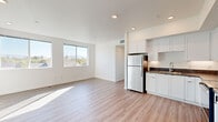 Located at 2375 Old Sonoma Road in Napa, CA, this well-appointed 2-bedroom, 2-bathroom residence offers a thoughtfully designed single-floor layout. The open-concept living, dining, and kitchen area forms the heart of the home, bathed in natural light from large windows that frame views of the surrounding hills and neighborhood. Light wood-tone flooring runs throughout the main living areas, giving the space a clean, contemporary feel.

The kitchen is efficiently designed with white shaker-style cabinetry extending to the ceiling, dark countertops, and a full suite of stainless steel appliances including a refrigerator, range, microwave, and dishwasher. Recessed lighting illuminates the space throughout.

Both bedrooms are carpeted and feature windows that bring in natural light and outdoor views of mature trees and the hillside beyond. Each room includes dedicated closet space. The primary bedroom offers a comfortable footprint with its own bathroom access.

The two bathrooms are finished in a clean, modern style — one featuring a tub/shower combo with tiled surround and white cabinetry, and the other a more streamlined design with wood-tone flooring and a vanity. A hallway connects the private areas of the home, completing this well-organized and light-filled residence in the heart of Napa Valley.