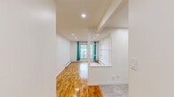 Located on Avenue Madison in Montréal, this well-appointed 1-bedroom, 1-bathroom unit offers a thoughtfully designed layout across a single floor. Warm, polished hardwood flooring flows throughout the living spaces, reflecting natural light and adding a sense of brightness and warmth to every room.

The combined kitchen and living area forms the heart of the unit. The kitchen stands out with its contemporary dark wood cabinetry, stone-finish countertops, large-format white subway tile backsplash, and recessed lighting — creating a sleek, modern aesthetic. A white electric range and ample cabinetry provide both style and practicality.

The living room is open and airy, with clean white walls, recessed pot lights, and baseboard heating. A glass-paneled interior door adds a touch of architectural detail, connecting the space with a sense of openness.

The well-sized bedroom features a window with views of surrounding greenery, curtain rods, and a sliding door that opens to an outdoor area, filling the room with natural light. An additional room offers flexible space for storage or a secondary use.

The bathroom is finished with elegant marble-look porcelain tiles lining the tub surround, giving it a refined, upscale feel. The overall ambiance of the unit is clean, modern, and move-in ready.