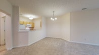 Located at 500 Aqua Marine Blvd in Avon Lake, Ohio, this single-floor unit offers a well-organized layout designed for comfortable everyday living. The open dining area is anchored by a modest chandelier and flows seamlessly into the living space, both finished with neutral-toned wall-to-wall carpeting that carries throughout the bedroom areas. Textured ceilings add a classic touch consistent across the main living spaces.

The kitchen features light maple cabinetry, laminate countertops, and white appliances including a refrigerator, range, and built-in microwave. A pass-through counter connects the kitchen to the dining area, enhancing the open feel. Tile flooring extends through the kitchen and into a utility hallway, where a full-size washer and dryer are conveniently housed alongside closet and interior door access.

The bedrooms are generously sized, with large windows that invite natural light and views of surrounding greenery. One bedroom features notably elevated ceilings, lending a more spacious feel.

Two bathrooms serve the unit: one with a tub-shower combination, single vanity, and tile flooring, and a second with a glass-door shower enclosure and a wider vanity with drawer storage. Both bathrooms maintain a clean, neutral palette with brushed nickel fixtures throughout.