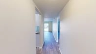 Located at 2800 Tift Ave N in Tifton, Georgia, this two-bedroom, one-bathroom single-floor unit offers a practical and well-organized layout. Wood-look plank flooring runs throughout the home, lending a cohesive and clean aesthetic to every room. Crisp white walls and neutral tones create a bright, open atmosphere across the entire space.

The living room is a comfortable and airy area anchored by a full-height sliding glass door fitted with vertical blinds, allowing generous natural light and providing outdoor access. The kitchen features white cabinetry, granite-style countertops, a stainless steel refrigerator, and a dishwasher, all arranged in an efficient galley-style layout with an adjacent pantry closet for additional storage.

Two hallways connect the rooms, offering a logical flow through the home. The primary bedroom is a well-proportioned retreat with a large window that brings in natural light. The second bedroom also features a sliding glass door, further enhancing the sense of brightness. Both bedrooms have textured ceilings and dedicated closets. The unit includes two closets in total, ensuring ample storage throughout. The single full bathroom completes this efficiently designed and move-in-ready home.