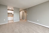 Located at 3005 Galley Rd in Colorado Springs, Colorado, this single-floor unit offers a practical and comfortable layout with neutral gray walls and wall-to-wall carpet throughout the living and bedroom areas. The spacious living room is bathed in natural light from a sliding glass door that opens to a private balcony, providing an inviting outdoor retreat. A baseboard heating system ensures comfort throughout the colder Colorado months.

The kitchen features tile countertops, a double stainless steel sink, white cabinetry with brushed nickel hardware, and tile flooring, creating a clean and functional workspace. It connects seamlessly to the main living area via an open passageway.

The hallway leads to the bedroom, which includes a sliding-door closet equipped with a built-in shelving and hanging rod system, offering ample storage. The bathroom is outfitted with a full tub and shower combination with clean white surround panels. Throughout the unit, textured ceilings add a classic architectural detail, while white trim and doors provide crisp contrast against the soft gray walls. The layout is efficient and well-connected, making thoughtful use of the available space.