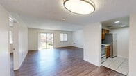 Located at 7304 Good Samaritan Ct in El Paso, Texas, this single-floor, 2-bedroom, 2-bathroom home offers a well-organized layout across a comfortable footprint. The open living and dining area is a highlight of the space, featuring warm wood-look flooring, a textured ceiling, and a sliding glass door flanked by a window that floods the room with natural light and provides direct access to an outdoor patio area with neighborhood views.

The galley-style kitchen is equipped with warm oak cabinetry, light countertops, tile flooring, and includes a range, dishwasher, and refrigerator — offering efficient use of space with ample storage.

The spacious primary bedroom features wood-look flooring, a ceiling fan with light fixture, and a window allowing natural light. It is complemented by generous closet space, including a walk-in closet with wire shelving on both sides. The second bedroom is bright and well-proportioned with matching flooring.

Both bathrooms feature tile flooring and wood-toned vanities. One includes a tub-shower combination, while the other offers a walk-in shower — both equipped with grab bars for added accessibility. With four closets throughout, storage is plentiful, making this a practical and comfortable home in El Paso.