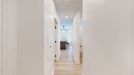 Located in Columbus, Ohio's German Village area, this single-floor unit at 850 Jaeger St. offers a thoughtfully designed, modern living space with clean lines and contemporary finishes throughout. Light hardwood flooring flows seamlessly across the entire unit, complementing the crisp white walls and recessed lighting that keep the space bright and welcoming.

The open-concept kitchen is a standout feature, showcasing tall white shaker cabinets with matte black hardware, a herringbone tile backsplash, quartz countertops, and a full suite of stainless steel appliances. A kitchen island with seating provides both additional prep space and a casual dining option. Natural light streams in through a large window, enhancing the airy feel of the kitchen.

The living area offers a comfortable, open layout with multiple windows fitted with blinds, recessed lighting, and direct sightlines into the kitchen—ideal for an open, connected feel.

The bedroom is a calm retreat with soft recessed lighting and a walk-in closet with built-in shelving. An in-unit washer and dryer is conveniently located nearby.

The bathroom is a design highlight, featuring a white vanity with matte black fixtures, a quartz countertop, and a striking herringbone brick-pattern tile floor that adds warmth and character. A hallway connects all spaces efficiently, completing this well-planned, modern unit.