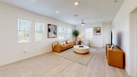 Located at 5181 Monte Vista Drive in Riverside, California, this well-appointed 3-bedroom, 3-bathroom residence offers a thoughtfully designed single-floor layout with a bright, contemporary aesthetic throughout. The open-concept living room is anchored by light wood-look flooring, a ceiling fan, and multiple windows that flood the space with natural light and frame outdoor views, creating an airy and welcoming atmosphere. The kitchen is a standout feature, showcasing crisp white cabinetry, quartz countertops, stainless steel appliances, recessed lighting, and a central island with a sink — ideal for both everyday cooking and entertaining. Each of the three bedrooms is carpeted for comfort, outfitted with a ceiling fan, and features windows overlooking the surrounding greenery. The spacious primary bedroom connects to a dedicated walk-in closet and an en suite bathroom featuring a glass-enclosed shower with marble-look tile surround and a white vanity. The additional bathrooms are equally refined, with one offering a full soaking tub framed by matching marble-look tile. Clean white walls, light wood-tone flooring in common areas, and gold and brushed nickel hardware details tie the home together with a cohesive, modern sensibility throughout.