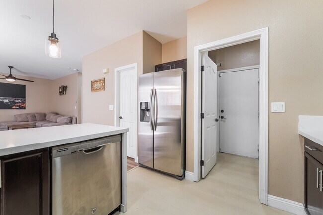 Kitchen featuring light countertops, appliances with stainless steel finishes, dark brown cabinets, - 1179 Antoinette St