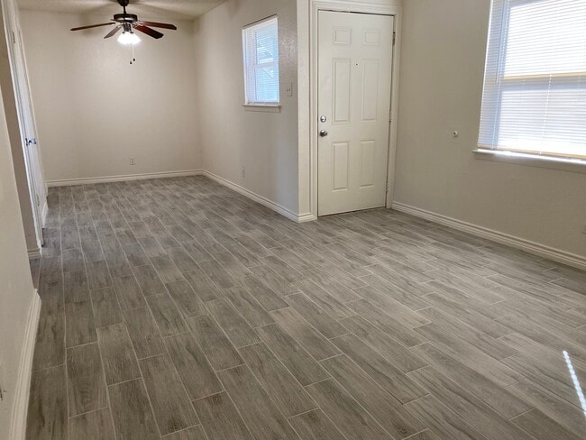 Living Room & Dining with TIle Floors - Lions Court Apartments