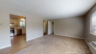 Located in the Partridge Hollow neighborhood of Chicopee, MA, this single-floor unit offers a well-organized layout with functional living spaces throughout. The renovated kitchen is a standout feature, showcasing crisp white shaker-style cabinetry, light granite-look countertops, wood-look vinyl flooring, and a full suite of stainless steel appliances including an electric range, dishwasher, and refrigerator. A window above the sink brings in natural light, enhancing the clean, modern feel of the space. The living area is generously sized, featuring neutral-toned carpet, a textured ceiling, and a ceiling fan, creating a comfortable and airy atmosphere. Multiple bedrooms are carpeted and finished with the same warm neutral tones, each offering natural light through slatted windows and baseboard heating. Several bedrooms include closets, providing practical storage. One bedroom also features a wall-mounted HVAC unit. The bathroom includes a full bathtub surrounded by classic light blue tile, adding a retro character to the space. Consistent use of white trim, neutral walls, and textured ceilings ties the rooms together for a cohesive, move-in-ready aesthetic throughout the unit.