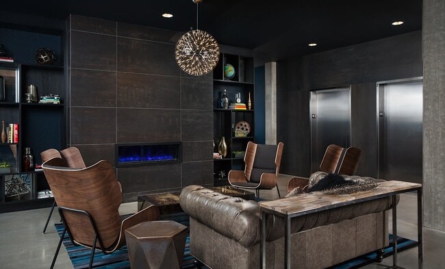 Shelves and a lit fireplace turn this corner into a second living room. - Pike Motorworks