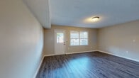 Located at 1750 20th Avenue Dr NE in Hickory, North Carolina, this single-floor residence offers a functional and comfortable layout throughout. The living areas feature durable wood-look hard-surface flooring in a neutral tone, complemented by textured ceilings and warm beige walls that create a welcoming atmosphere. Natural light flows in through multiple windows fitted with blinds, giving the main living spaces a bright and open feel. Entry doors with glass panels further enhance the connection to the outdoors.

The galley-style kitchen is efficiently designed with white cabinetry lining both sides, dark countertops, a coil-burner electric range, and a full-size refrigerator — all finished in white. The layout maximizes storage and workspace, with a hallway leading conveniently to adjacent areas of the home.

The bedrooms are carpeted in soft blue-grey tones and each features a ceiling fan with light fixture, providing comfort year-round. Windows in the bedrooms offer views of the surrounding landscape, filling the rooms with natural light. Additional bedroom spaces offer the same carpet flooring and ventilation through ceiling registers.

The bathrooms are finished with wood-look flooring, white vanity cabinetry, light countertops, a full tub-shower combination, and chrome fixtures, providing a clean and practical design throughout.