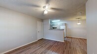 Located at 1018 South Birch Street in Sapulpa, Oklahoma, this single-story residence offers a thoughtfully organized layout encompassing one bedroom, one bathroom, a combined kitchen and living area. The living room features durable wood-look plank flooring, neutral gray walls, a ceiling fan with light fixture, and a window that allows natural light to fill the space. It opens conveniently toward the kitchen, creating a cohesive and functional common area. The kitchen is well-equipped with ample light wood cabinetry, a full suite of white appliances including a range, refrigerator, and dishwasher, a double-basin sink, and a breakfast bar peninsula that separates it from the living space. Light wood-look flooring continues throughout, and a pendant light adds a warm accent. The bedroom offers generous proportions with soft carpeting, a ceiling fan, a window with outdoor views, and direct access to additional storage. The bathroom is notably spacious and features accessibility-minded design, including stainless steel grab bars near the tub and toilet, wood-look flooring, a single-basin vanity with mirror, and a tub-shower combination. Textured ceilings are consistent throughout the residence, contributing to its classic character.